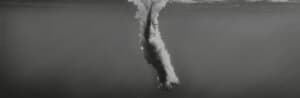 Black and white photo of diving into pool